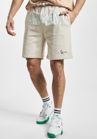 Karl Kani COLLEGE SIGNATURE  - Donji dijelovi trenirke - off white