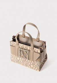 Beige tote bag with printed logos, structured design, dual top handles, and a zippered compartment. Textured surface with accents.