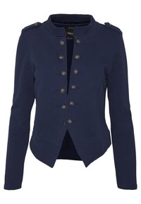 Veste pour femme bleu marine à manches longues avec des boutons argentés disposés en deux rangées verticales, des épaulettes, ouverture sur le devant et ourlet cintré.