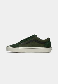 Green suede sneaker with a black side stripe, round toe, lace-up front, and white rubber sole. Textured upper with contrasting black accents.