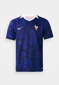 Maglia da football blu navy con design testurizzato, collo bianco ed emblematico gallo arancione. Caratterizzata dal logo Nike e colori a contrasto.