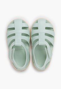 Light green rubber sandals featuring a closed-toe design, multiple ventilation cutouts, and a beige sole with a soft texture.