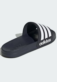Black slide sandal with white three stripes and "adidas" logo; made of smooth synthetic material with a textured sole for grip.