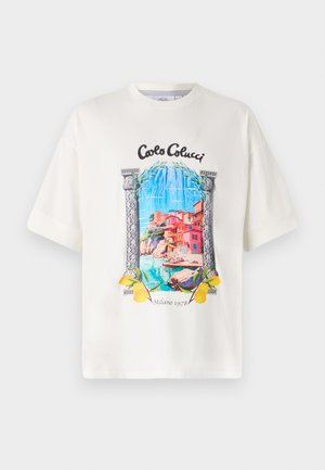 White cotton t-shirt featuring a colorful coastal graphic print, bordered by ornate pillars and yellow lemon accents at the bottom.