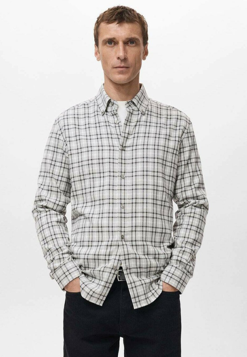 Chemise à carreaux gris avec col boutonné, manches longues et coupe légèrement ample, fabriquée en tissu texturé. Dotée d'une fermeture à boutons à l'avant.