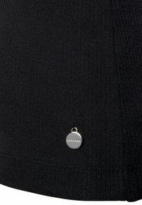 Black ribbed fabric with a silver logo tag at the hem. The texture is soft with a fitted shape, suitable for various styles.