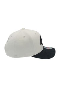 Cappellino da baseball con una corona in tessuto bianco e visiera nera. Presenta un logo sul lato e un motivo di cuciture decorative.