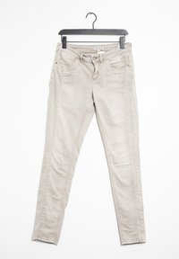 Jeans skinny beige claro fabricados en una mezcla de algodón, con bolsillos frontales, trabillas para el cinturón y detalles de costura a lo largo de los lados.