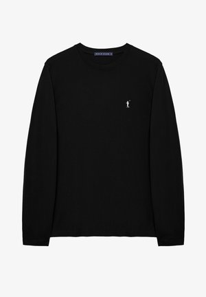 Černé tričko s dlouhým rukávem z bavlny, s malou bílou vyšívanou postavičkou na hrudi a kulatým výstřihem. Pohodlný běžný střih.