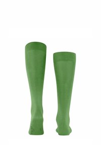 Calze al ginocchio in verde intenso, con una texture liscia e un polsino a costine per una migliore vestibilità. Branding discreto sulla parte inferiore.