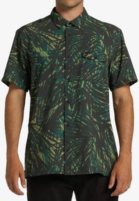 Short-sleeve button-up shirt, dark with green and yellow abstract leaf patterns, featuring a patch pocket and a standard collar.