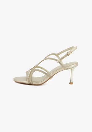 Sandalo dorato con tacco alto e sottili cinturini decorati con strass e chiusura a fibbia intorno alla caviglia.