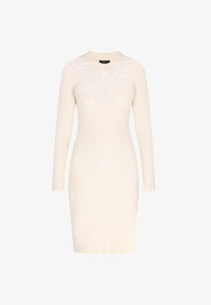 Romantische ribgebreide lange mouw jurk in crème met een ronde hals en witte pailletten die de bovenkant van de borst versieren.