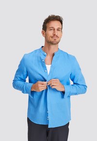 Blue linen shirt with a band collar, long sleeves, and front buttons. The fabric has a smooth texture and casual fit.
