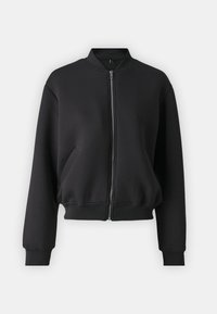 Veste bombers noire en tissu doux, dot ée d'une fermeture éclair, de poignets côtelés et de poches latérales. Encolure arrondie simple avec une coupe décontractée.