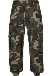 Camo cargo pants made of durable cotton blend. Features multiple pockets, tapered cuffs, and a mix of green, brown, and black patterns.