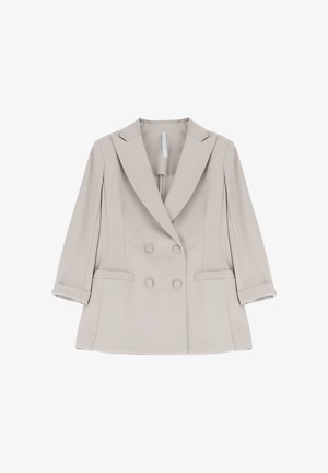 Blazer doppiopetto da donna color beige chiaro con revers a incavo, maniche lunghe arrotolate ai polsini e due tasche frontali con pattina.