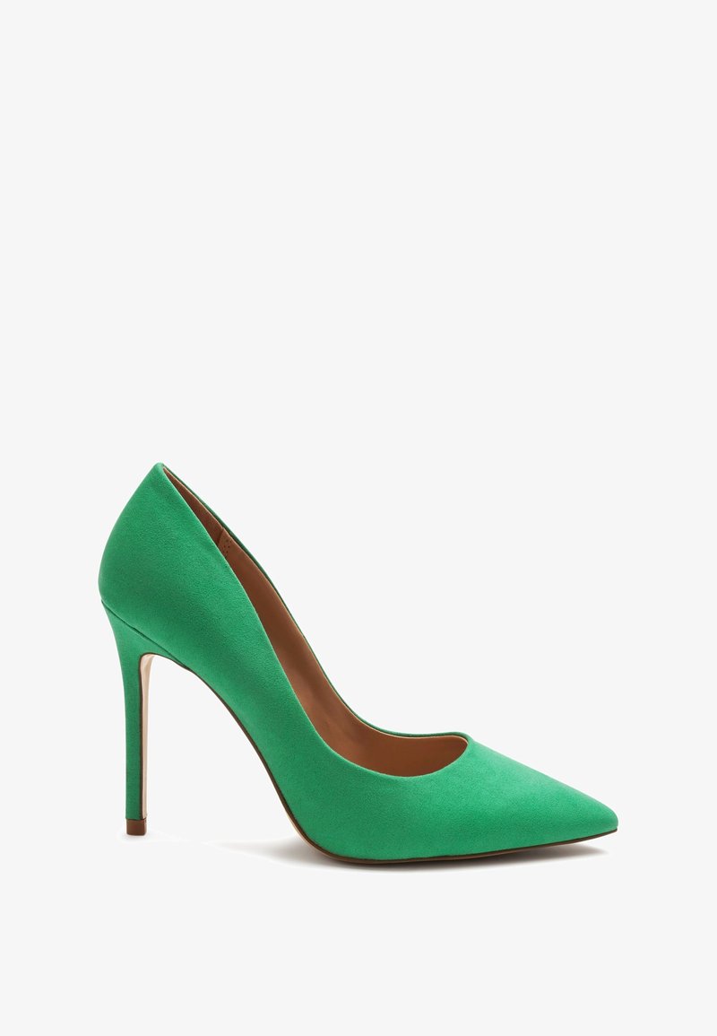 Zielone zamszowe czółenka na wysokim obcasie z wąskim obcasem typu stiletto i brązowym wnętrzem, pokazane na tle białym.
