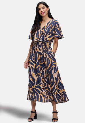 Maxi dress in navy and beige with an abstract pattern. Features short sleeves, a V-neck, and an elastic waist for a relaxed fit.