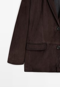Brown suede blazer with a notched lapel, two buttons, and a single chest pocket. Smooth texture and tailored fit.