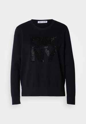 Black sweater with long sleeves and ribbed cuffs, featuring a glossy, large "DKNY" logo adorned with black studs on the front.