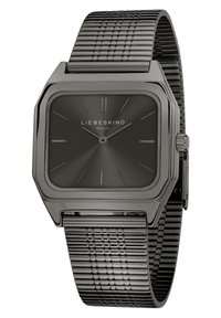 Orologio quadrato in metallo nero con bracciale a rete testurizzato, caratterizzato da un quadrante minimalista nero, indicatori delle ore argentati e logo posizionato alle 6.