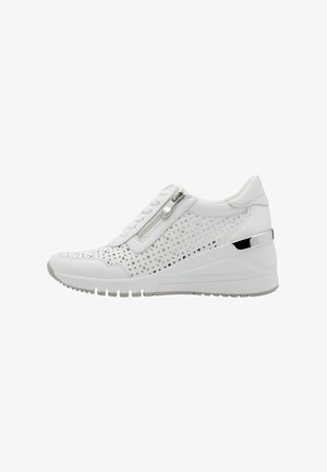 White sneaker featuring perforated design, silver zipper, and wedge heel. Smooth material with textured accents and rubber sole.