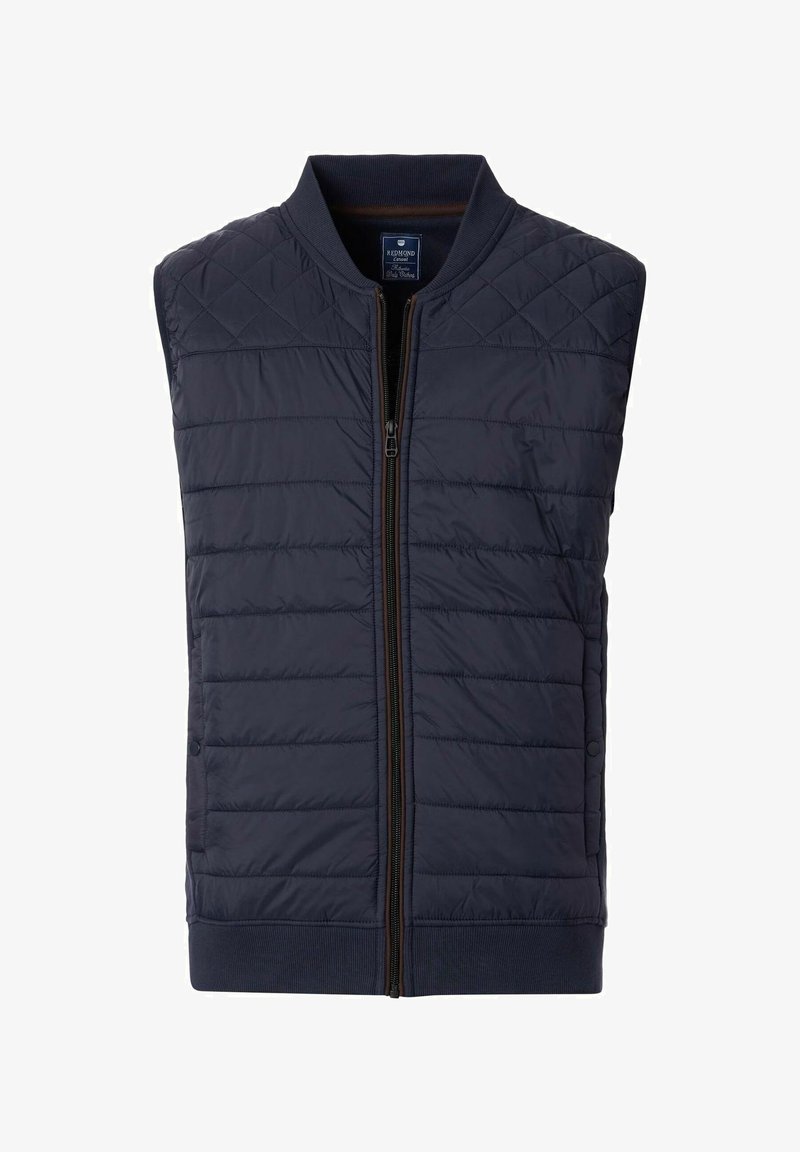 Marineblau gesteppte Weste mit einem gerippten Kragen, durchgehendem Reißverschluss und seitlichen Knopfdetails. Hergestellt aus leichtem, isoliertem Material.