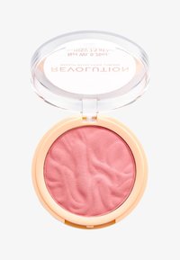Blush in polvere rotondo di un delicato rosa, con una superficie testurizzata, racchiuso in una cassetta circolare trasparente con una finitura esterna tono pesca.
