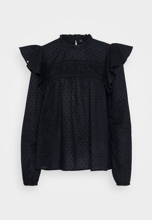 Crna bluzica s rukavima na volane, teksturiranim materijalom s malim točkastim uzorcima i visokim izrezom s nabranim detaljima.