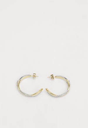 Two hoop earrings featuring a combination of gold and silver tones, smooth metallic finish, and a curved design with delicate detailing.
