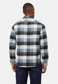 Geruite blouse met lange mouwen in tinten zwart, wit en blauw. Gemaakt van geweven stof met knoopmanchetten en een afgeronde zoom.