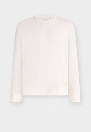 Kerge, soonikkoes pikem varrukatega kampsun helevalgel toonil. Omadusi on ümarlõikega kaelus, sirge lõige ja peen logo silt all vasakul.