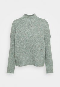 Suéter de punto verde menta con cuello alto, hombros caídos y puños acanalados. Presenta motas multicolores en toda la tela.