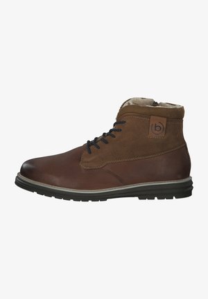 Brown leather and suede ankle boots with black laces, rubber sole, padded collar, and a logo patch on the side. Textured surface detail.