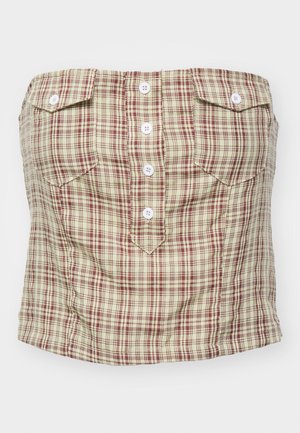 Haut bustier à carreaux en beige clair avec un motif à tartan maroon et vert. Il possède quatre boutons à l'avant et deux poches sur la poitrine.