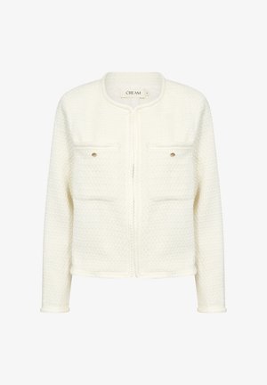 Weißer Textur-Jacke mit rundem Ausschnitt, zwei vorderen Taschen und goldenen Knopfdetails. Verfügt über eine gewebte Borte entlang der Kanten.