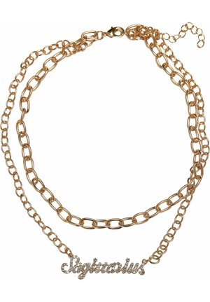 Kuldtooni kihiline kettidega kaelakee, millel on kätkeline "Jäär" ripats, millel on selged rhinestone'id. Kettide silmad varieeruvad suurustes.