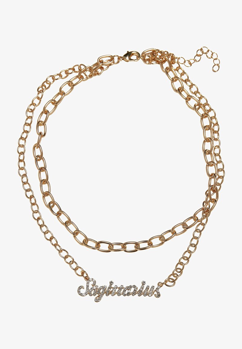 Kuldtooni kihiline kettidega kaelakee, millel on kätkeline "Jäär" ripats, millel on selged rhinestone'id. Kettide silmad varieeruvad suurustes.