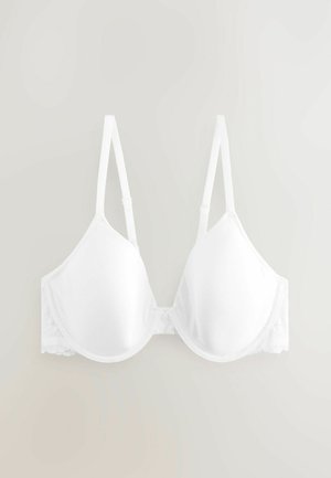 Hvid bh med formede skåle, justerbare stropper og blonde detaljer på siderne. Glat tekstur med en klassisk trekantet form.