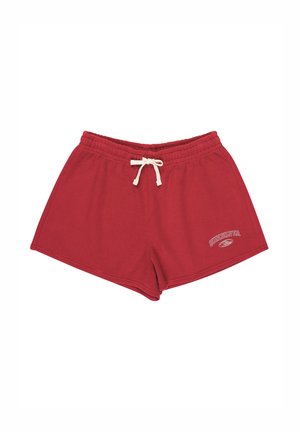 Red athletic shorts made of soft cotton, featuring an elastic waistband with drawstring and a small logo printed on the lower side.