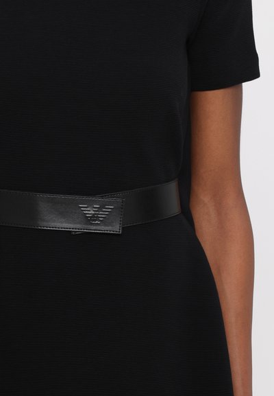 Black leather belt featuring a smooth finish and embossed logo. The design is minimalist, with a rectangular metal buckle.