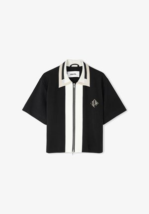 Short-sleeve black shirt with a white front stripe, zip closure, and a beige-accented collar. Features an embroidered logo.