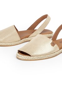 Kultaiset kimalteet slingback-sandaalit, joissa on avoin varvas, kudottu jutee-reuna ja tasapohja, jossa on ruskea nahkasisus.