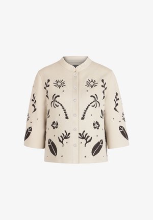 Krēmkrāsas pogājama jaciņa ar melnu izšūtu sauli, palmām, lapām un ziedu rakstiem, tai ir trim ceturtdaļām piedurknes un apaļš apkaklis.