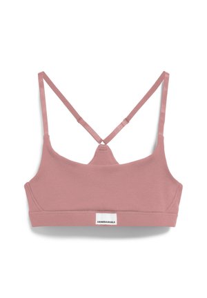 Lichtroze katoenen bralette met een geribbelde textuur, met een crisscross rugontwerp en een klein wit merklabel aan de onderkant.