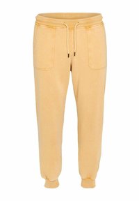 Joggers en coton jaune avec un waistband élastique, fermeture à cordon, deux poches latérales et des poignets côtelés. Texture lisse, coupe décontractée.