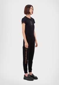 EA7 Emporio Armani TROUSER - Träningsbyxor - black