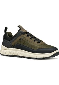 Men's sneakers in olive green and black, featuring a textured mesh upper and a chunky cream midsole with a durable rubber outsole.