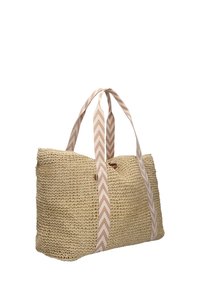 Geweven rieten tote bag met beige en witte chevronpatroon handvaten, rechthoekige vorm, open bovenkant en aardse textuur.